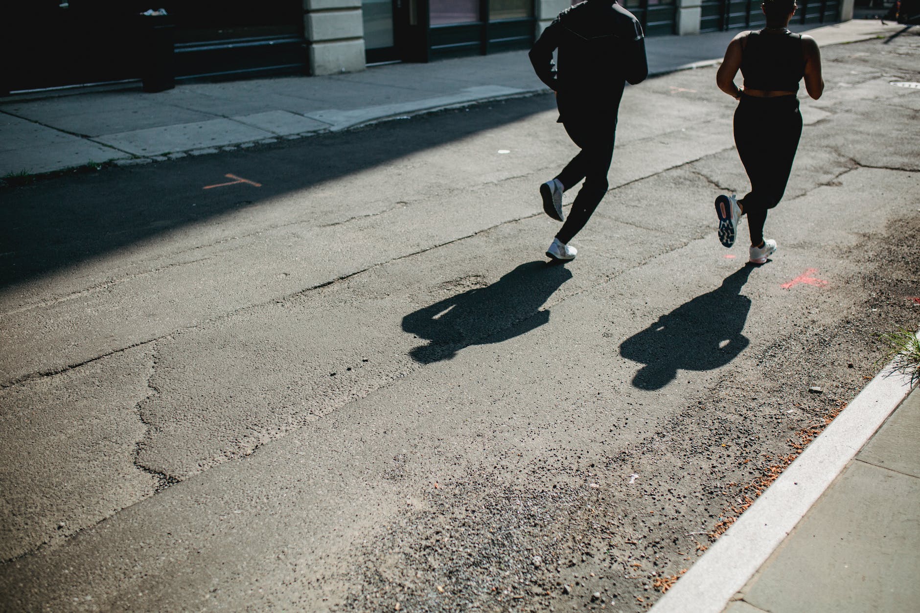 people jogging on a city street